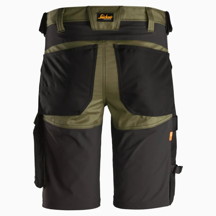 Back view of olive and black cargo shorts with large rear pockets, side cargo pocket, and waist belt loops; brand label on waistband visible.