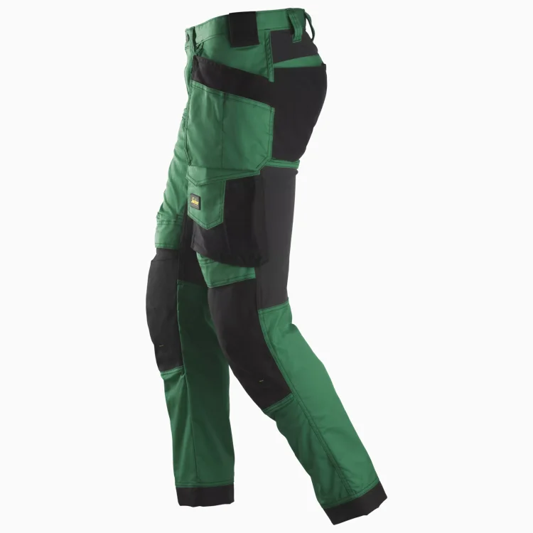 Side view of green and black cargo work pants with multiple pockets and reinforced knees for durability.