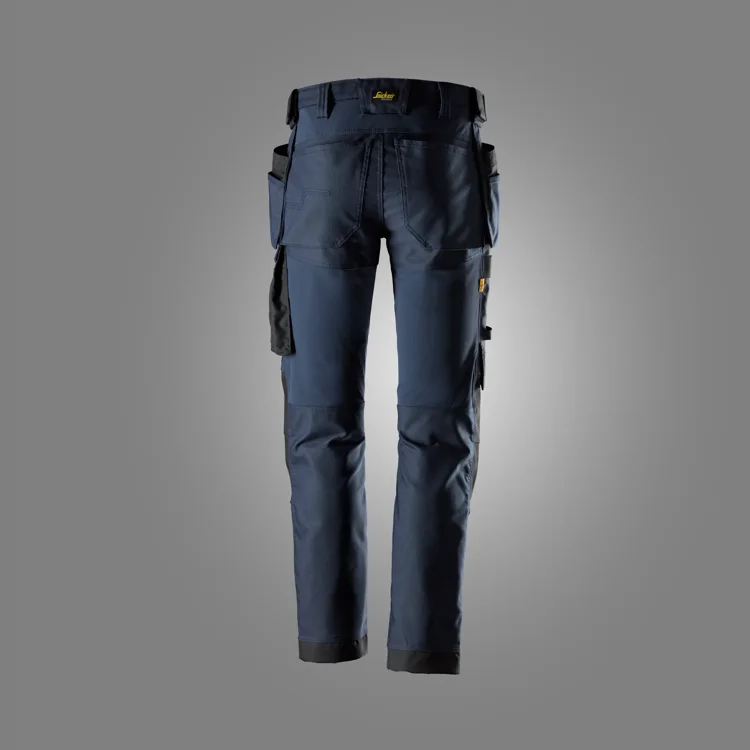 Back view of navy blue cargo work pants with multiple tool pockets and reinforced knees/ cuffs edge visible.