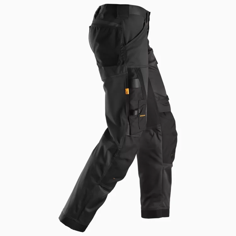 Black tactical cargo pants with multiple pockets and orange pull tabs, shown from the side to highlight utility features